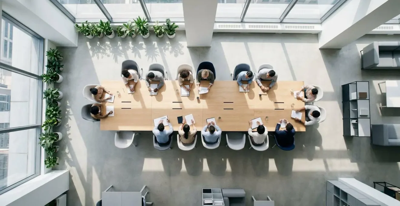 Vue en plongée d'une équipe collaborative travaillant sur une stratégie de sécurité informatique dans un environnement de bureau moderne